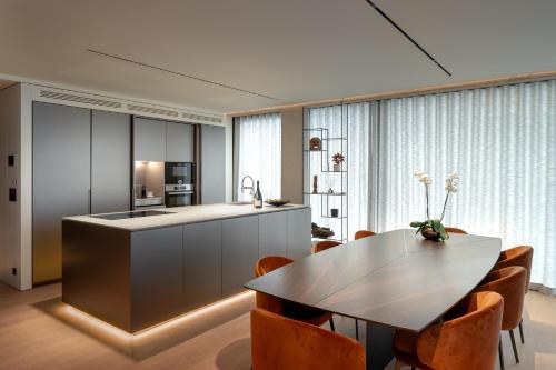 a kitchen and dining room with a table and chairs at Castle View Penthouse in Ljubljana
