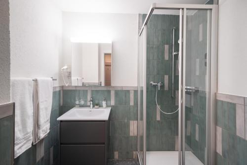 a bathroom with a sink and a shower at BetweenLakes Apartment 1st floor in Interlaken