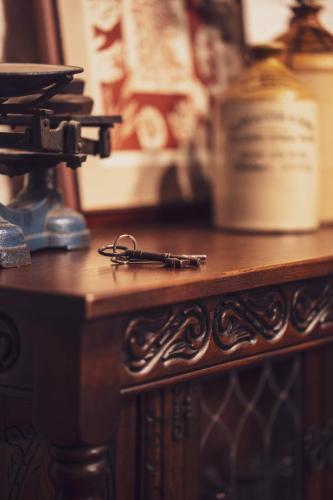 a wooden table with a pair of glasses on it at Pictor Hall Lodge in Buxton