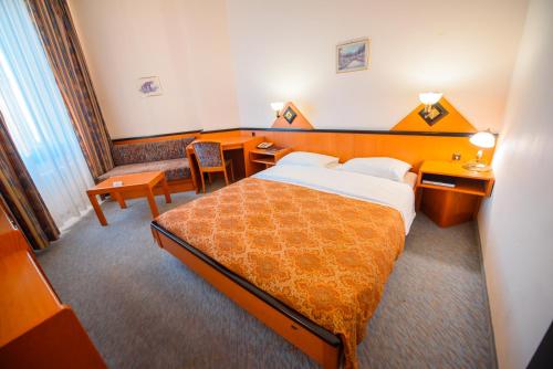 a hotel room with a bed and a desk at Kazakhstan Express in Almaty