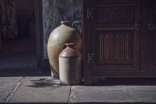 two large vases sitting next to a door at Pictor Hall Lodge in Buxton