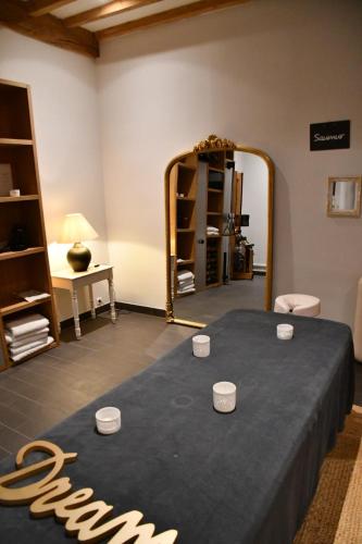 a dressing room with a table and a mirror at The Originals Boutique, Hôtel Le Londres, Saumur in Saumur