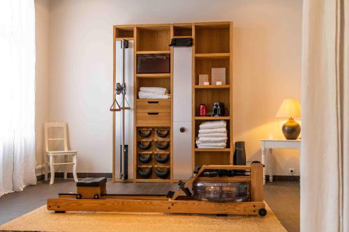a room with a refrigerator and a table in it at The Originals Boutique, Hôtel Le Londres, Saumur in Saumur