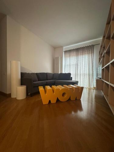 a living room with a couch and a wooden floor at Cà Vascello- Terrazza panoramica in centro in Asti