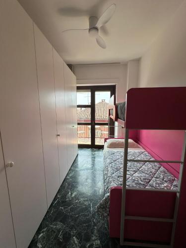 a bedroom with a bed and a ceiling fan at Cà Vascello- Terrazza panoramica in centro in Asti