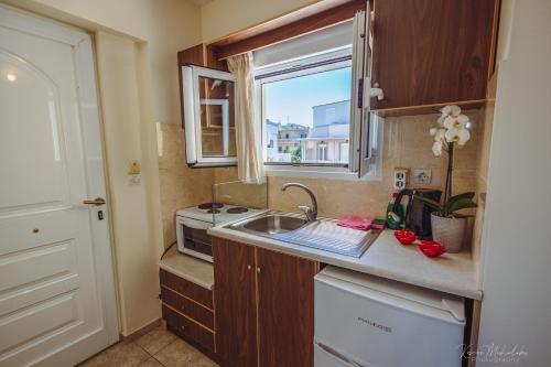 a small kitchen with a sink and a window at Vrokastro Apartments in Istro