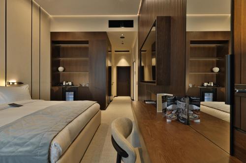a bedroom with a bed and a chair in a room at Emily Resort in Lviv