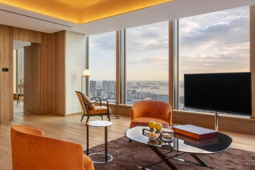 a living room with a large view of a city at Bvlgari Hotel Tokyo in Tokyo