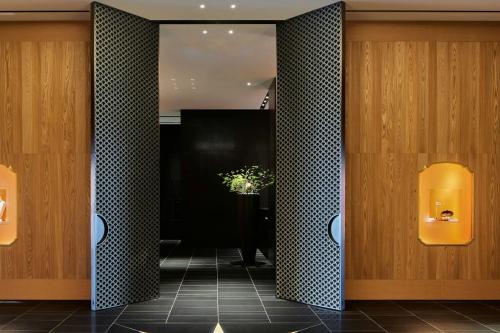a lobby with black and white tile and a plant at Bvlgari Hotel Tokyo in Tokyo
