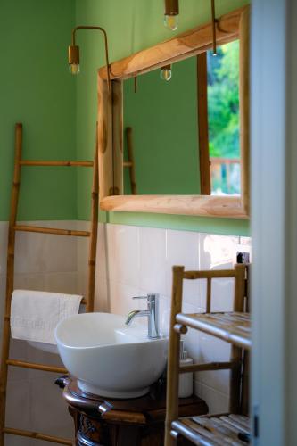 a bathroom with a white sink and a mirror at Villa Mafalda in Pietra Ligure
