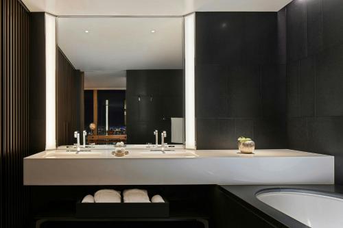 a bathroom with two sinks and a large mirror at Bvlgari Hotel Tokyo in Tokyo
