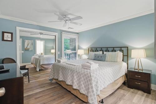 a bedroom with a large bed and a mirror at Hilton Head Beach Villas 20 in Hilton Head Island