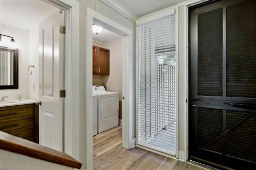 a bathroom with a door open to a bathroom with a sink at Hilton Head Beach Villas 20 in Hilton Head Island
