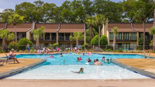 a group of people in the swimming pool at a resort at Hilton Head Beach Villas 20 in Hilton Head Island
