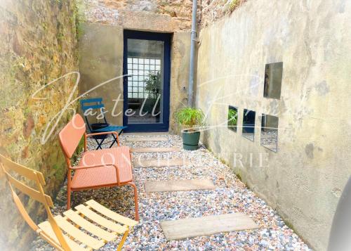 a group of chairs sitting in front of a door at Town House in Guingamp