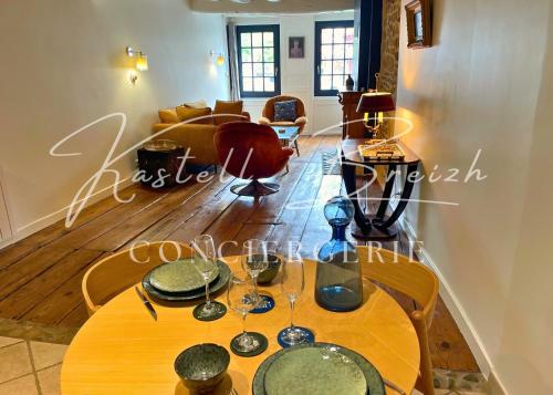 a dining room with a table with glasses on it at Town House in Guingamp