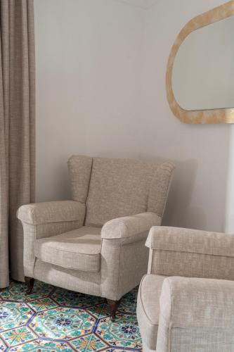 a chair and a recliner in a living room at Hotel Savoia in Positano