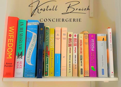 a shelf full of books on a wall at Town House in Guingamp