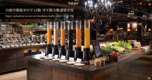 a display of wine bottles on a counter in a restaurant at Palais de Chine Hotel in Taipei