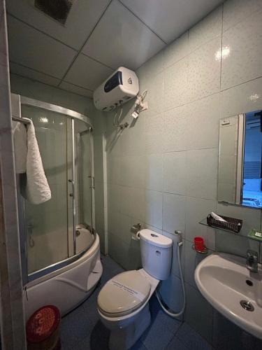 a bathroom with a toilet and a shower and a sink at Đức Lộc 2 Hotel in Hue