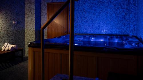 a bathroom with a tub with blue lighting at Gardone Palace Hotel in Gardone Riviera