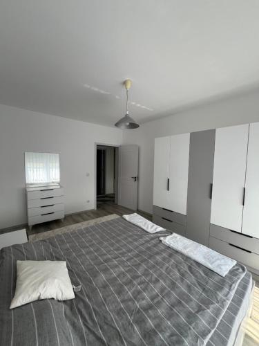 a white room with a large bed in it at Bright and Comfy in Kosovo Polje