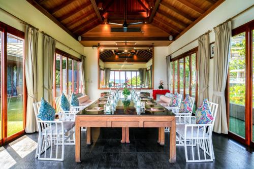 a large dining room with a long table and chairs at Ayara Kamala Resort & Spa - SHA Extra Plus in Kamala Beach