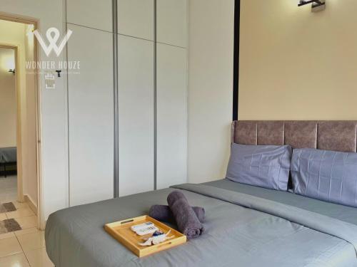 a room with a bed with a tray on it at 5pax Serene 3BR at Simfoni Heights with Batu Caves View in Batu Caves