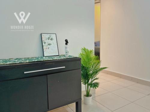 a black dresser in a room with a picture on it at 5pax Serene 3BR at Simfoni Heights with Batu Caves View in Batu Caves