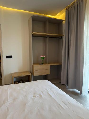 a bedroom with a white bed and a desk and shelves at Moddissi Charme in Trappola