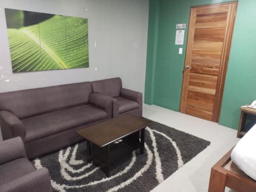a living room with a couch and a coffee table at Hope Pension House - Danao in Danao City
