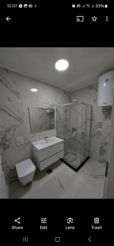 a bathroom with a sink and a toilet at Prizren Apartament in Prizren