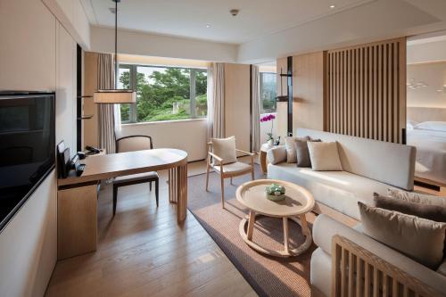 a living room with a couch and a table at Hilton Shenzhen Shekou Nanhai in Shenzhen