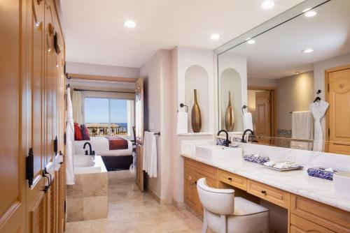 a bathroom with a sink and a large mirror at Unwind in Style Villa La Estancia Cabo in Cabo San Lucas