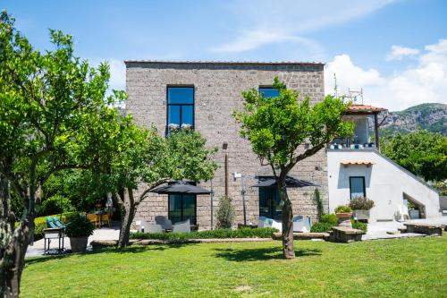 a large stone building with trees in front of it at 1912 Relais - Sorrento Coast in Piano di Sorrento