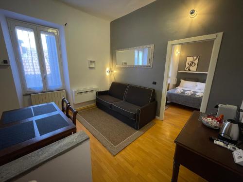 a living room with a couch and a bed at Antica corte Navigli-Darsena in Milan