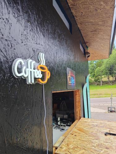a coffee sign on the side of a building at Hotel Tae Windsor in Myoko