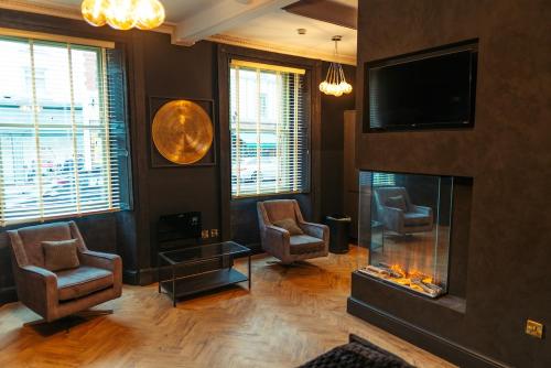 a living room with a fireplace and a tv at Judges suite apartment with spa facilities in Morpeth