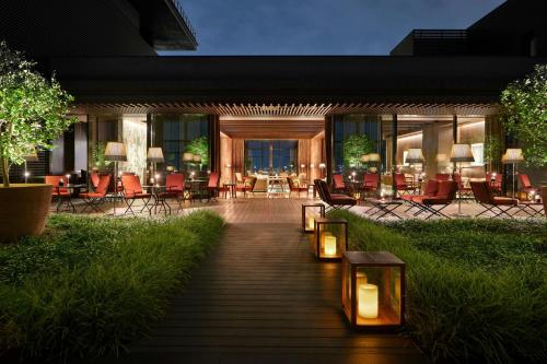 a hotel lobby with chairs and tables at night at Bvlgari Hotel Tokyo in Tokyo