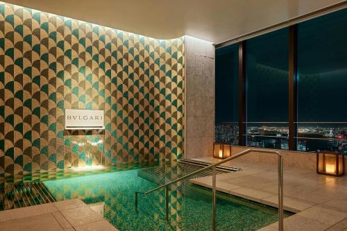 a bathroom with a swimming pool in a building at Bvlgari Hotel Tokyo in Tokyo