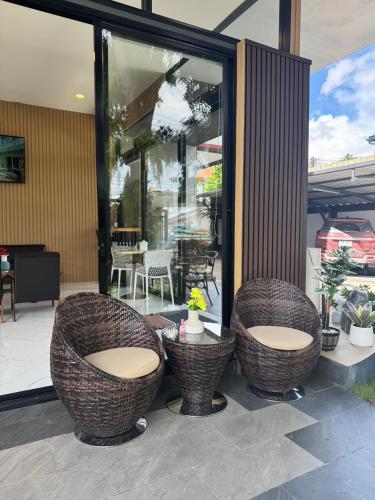 two wicker chairs and a table on a patio at Maesai Bliss Residence in Ban Pa Yang