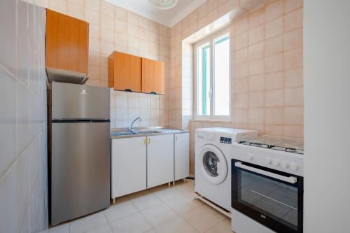 a kitchen with a refrigerator and a washing machine at Morfeo in Torre Canne