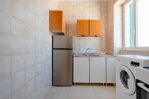 a kitchen with a refrigerator and a washing machine at Morfeo in Torre Canne