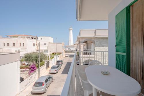 a balcony with a white table and a view of a street at Morfeo in Torre Canne