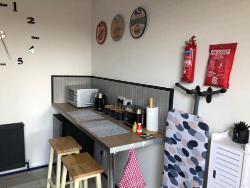 a small kitchen with a counter and a microwave at Stylish flat in Chesterfield near Peak District in Chesterfield