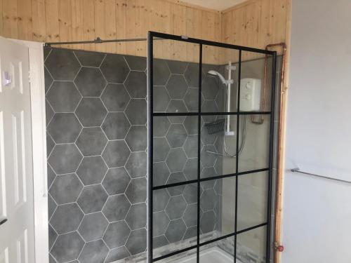a shower with a glass door in a bathroom at Stylish flat in Chesterfield near Peak District in Chesterfield