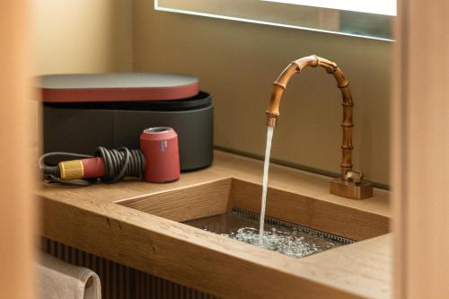 a kitchen sink with water coming out of it at QC Room Milano Porta Romana in Milan