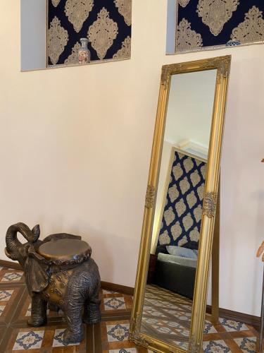 an elephant mirror in a room with a stool at Hotel Elita in Odesa