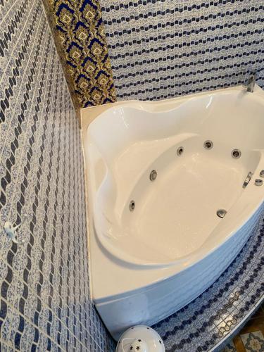 a white bath tub sitting on top of a wall at Hotel Elita in Odesa