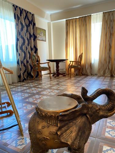 a room with an elephant statue and a table at Hotel Elita in Odesa